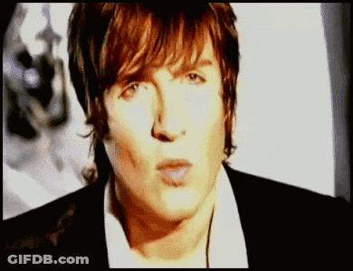 Man In White Shirt And Black Jacket Close Up GIF