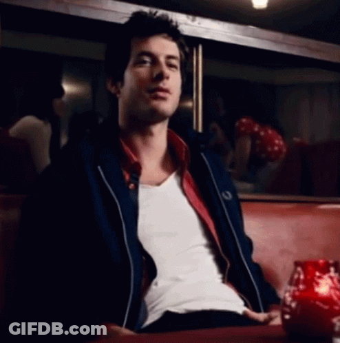 Man In White Shirt And Black Jacket On Red Couch GIF