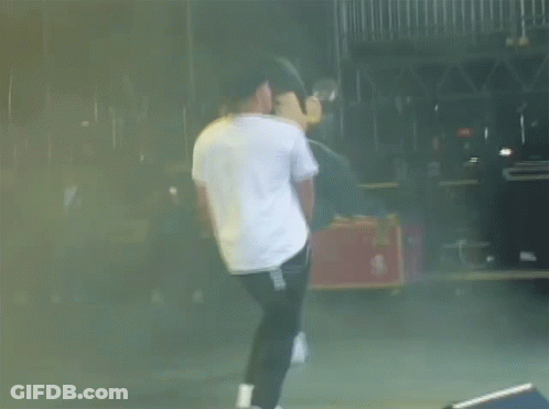 Man In White Shirt And Black Pants Dancing On Stage GIF