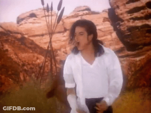 Man In White Shirt And Black Pants Standing In Desert GIF