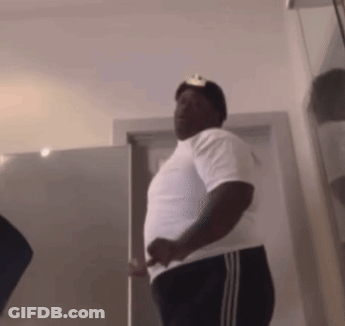 Man In White Shirt And Black Pants Standing In Front Of Door GIF