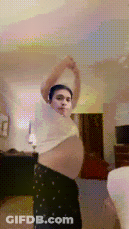 Man In White Shirt And Black Pants Stretching Arms GIF