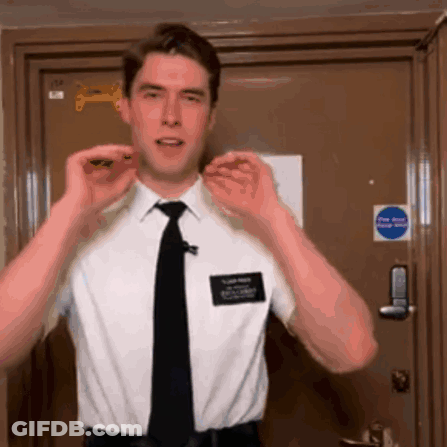 Man In White Shirt And Black Tie By Fire Exit Door GIF