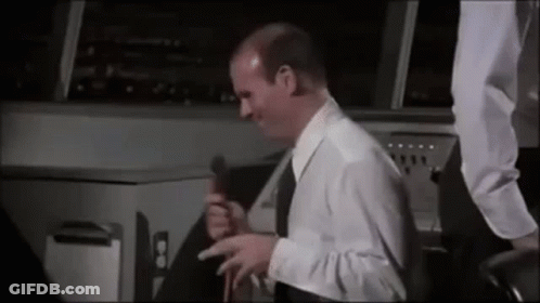 Man In White Shirt And Black Tie Holding Microphone GIF