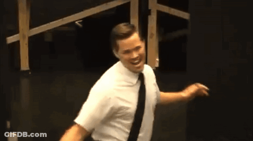 Man In White Shirt And Black Tie In Dark Room GIF