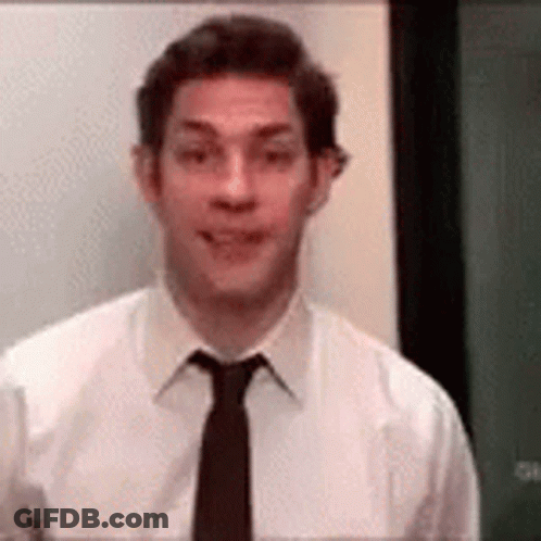 Man In White Shirt And Black Tie In Front Of Green Board GIF