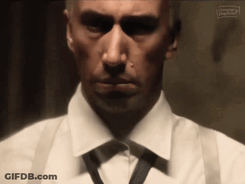 Man In White Shirt And Black Tie Looking At Camera GIF