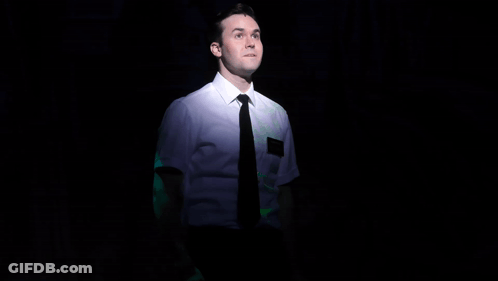 Man In White Shirt And Black Tie On Stage With Mickey GIF