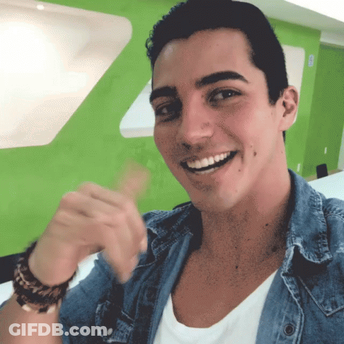Man In White Shirt And Blue Denim Jacket Smiling GIF