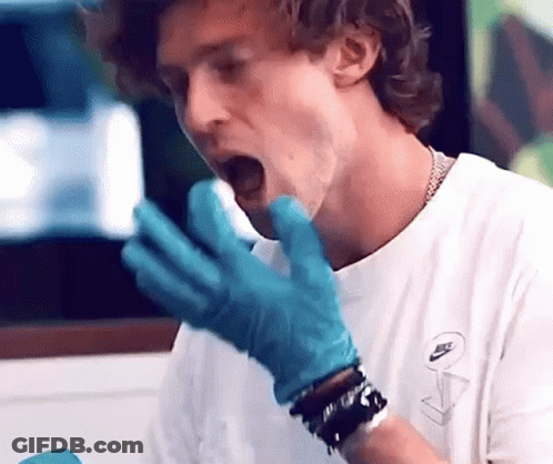 Man In White Shirt And Blue Gloves Eating GIF
