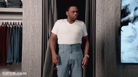 Man In White Shirt And Blue Jeans In Closet GIF