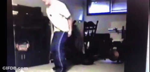 Man In White Shirt And Blue Pants Dancing In Dark Room GIF
