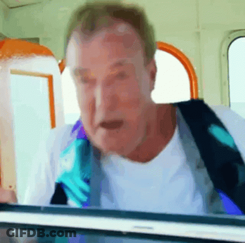 Man In White Shirt And Blue Tie Looking Out Window GIF