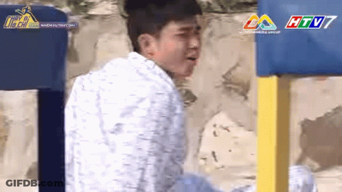 Man In White Shirt And Blue Yellow Fence GIF