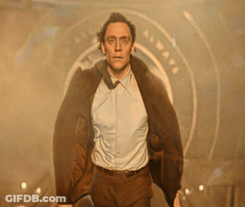 Man In White Shirt And Brown Jacket In Front Of Airways Sign GIF
