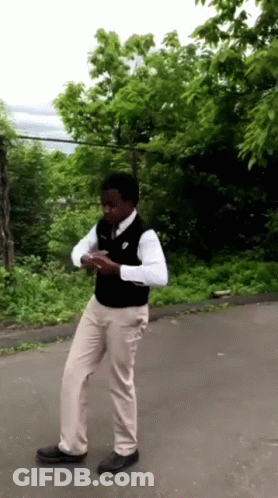 Man In White Shirt And Khaki Pants On Road GIF