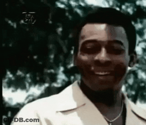 Man In White Shirt And Necklace Smiling GIF
