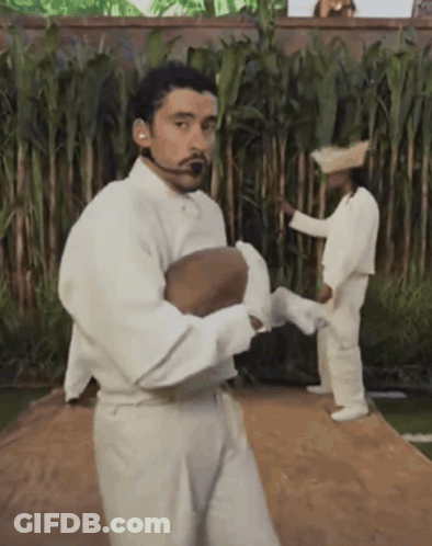 Man In White Shirt And Pants Holding Ball GIF