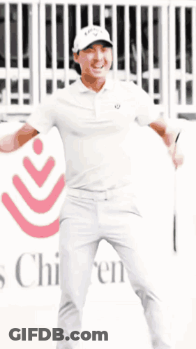 Man In White Shirt And Pants In Front Of Children's Hospital Sign GIF