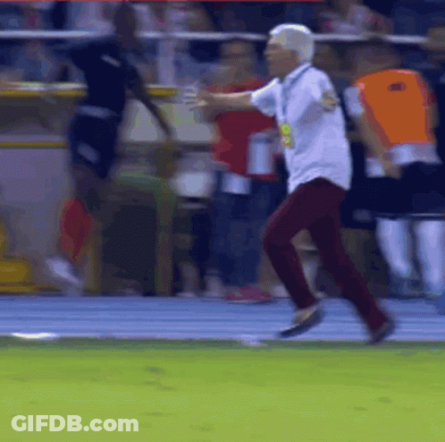 Man In White Shirt And Red Pants Running On Track GIF