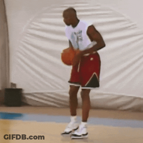 Man In White Shirt And Red Shorts Holding Basketball GIF
