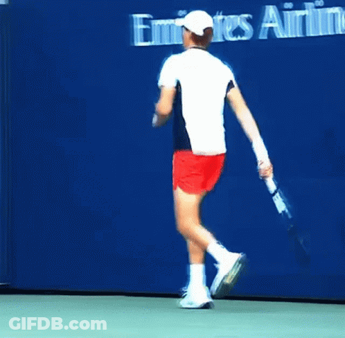 Man In White Shirt And Red Shorts Running On Tennis Court GIF