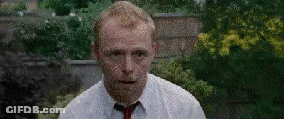 Man In White Shirt And Red Tie At Brick Wall GIF