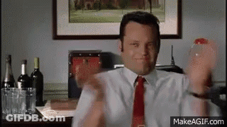 Man In White Shirt And Red Tie At Desk With Wine GIF