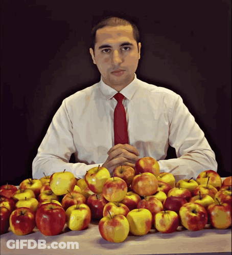 Man In White Shirt And Red Tie At Table With Apples GIF