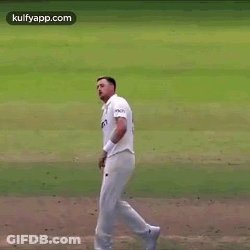 Man In White Shirt And Shorts Standing On Field With Hand In Air GIF