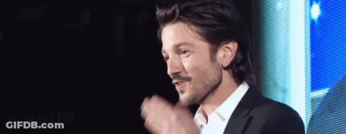 Man In White Shirt And Suit Before Screen GIF
