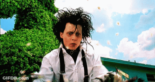 Man In White Shirt And Suspenders Standing Before Trees GIF