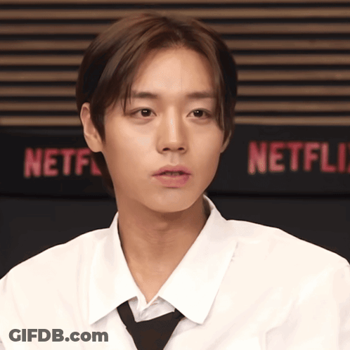 Man In White Shirt And Tie At Netflix Sign GIF