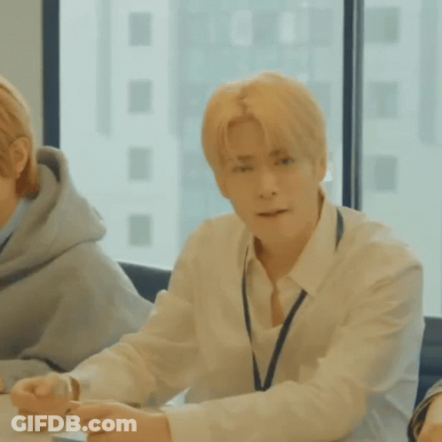 Man In White Shirt And Tie At Table With Window GIF