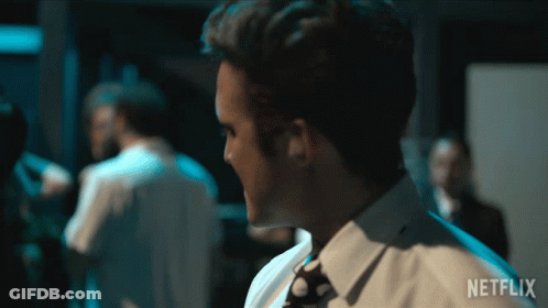 Man In White Shirt And Tie Before Netflix Sign GIF