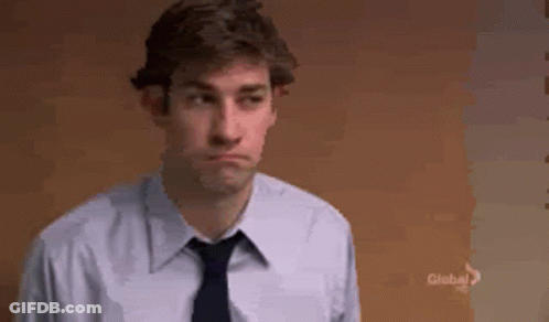 Man In White Shirt And Tie By Brown Wall GIF