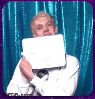 Man In White Shirt And Tie Holding Paper Over Face GIF