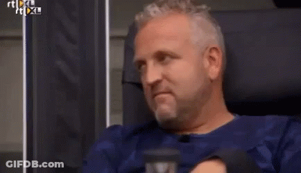 Man In White Shirt And Tie Laughing In Chair GIF