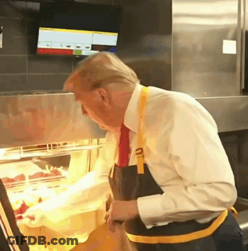 Man In White Shirt And Tie Looking At Food Display GIF