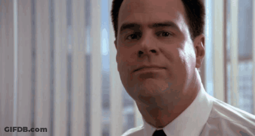 Man In White Shirt And Tie Looks At Camera GIF