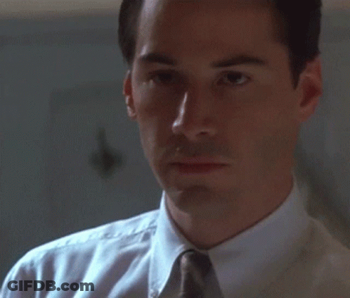 Man In White Shirt And Tie Looks At Something GIF