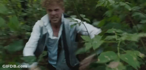 Man In White Shirt And Tie Running Through Forest GIF