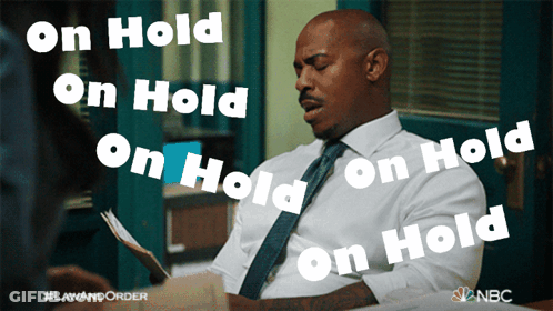 Man In White Shirt And Tie Saying On Hold GIF