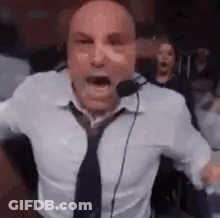 Man In White Shirt And Tie Screaming Into Microphone GIF