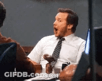 Man In White Shirt And Tie Sits At Desk GIF