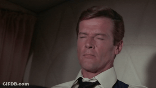 Man In White Shirt And Tie Sitting On Chair GIF