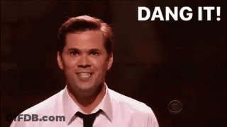 Man In White Shirt And Tie Smiling On Stage GIF