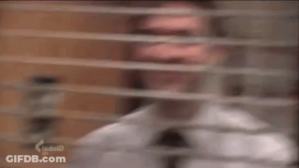 Man In White Shirt And Tie Smiling Out Window GIF