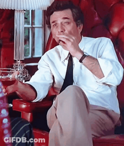Man In White Shirt And Tie Smoking In Red Chair GIF