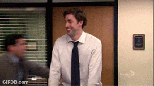 Man In White Shirt And Tie Standing By Window GIF